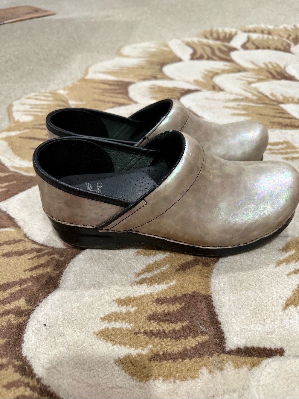 These are Dansko professional nurse clogs in a tan iridescent finish 39